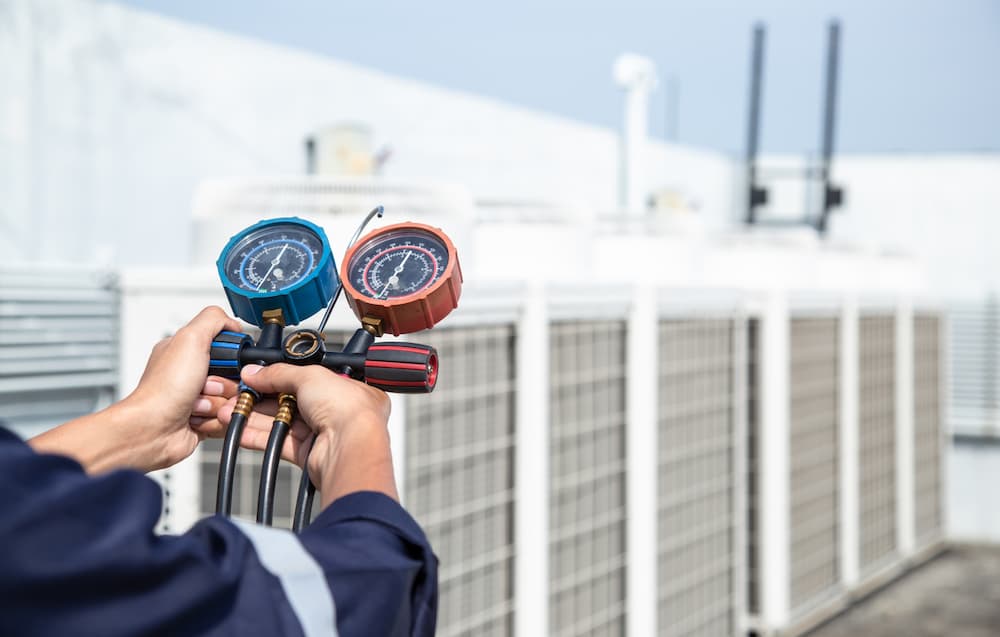 inspecting commercial air conditioner on roof